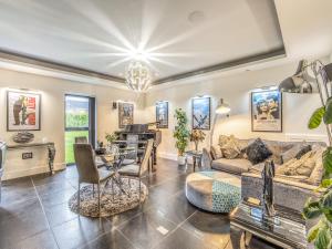 a living room with a couch and a table at The Paddocks Retreat in North Thoresby +15 photos