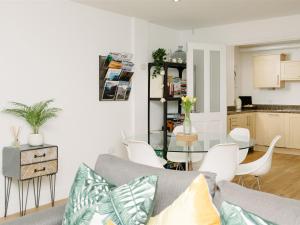 a living room with a couch and a table with chairs at 50 Bredon Court in Newquay +20 photos