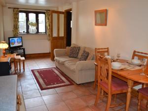 a living room with a couch and a table at Nu-Holme in Windermere