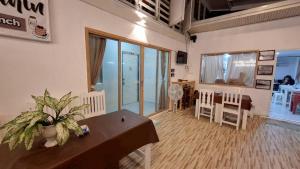 a room with a table and chairs and a dining room at Baan Puen Poonsuk in Hua Hin