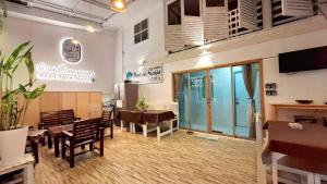 a restaurant with a table and chairs and a dining room at Baan Puen Poonsuk in Hua Hin