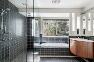 a bathroom with a tub and a sink and a window at Pure Indulgence in Merimbula +11 photos
