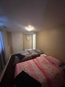 a small bedroom with a bed in a room at Private separate entrance suite in Oshawa