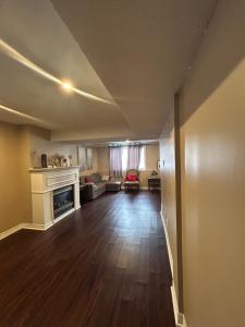 a living room with a couch and a fireplace at Private separate entrance suite in Oshawa