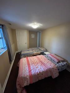 a bedroom with two beds and a window at Private separate entrance suite in Oshawa