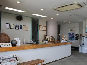 a bar in a store with a counter and a refrigerator at Hotel Kaijyokan in Isa