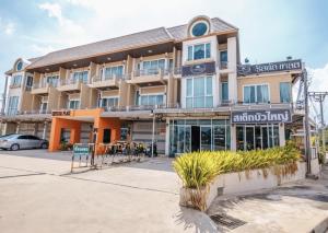 a building with a sign on the front of it at Crystal Place Buayai in Bua Yai