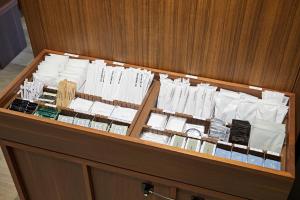 a wooden cabinet with alot of white papers on it at Sotetsu Fresa Inn Yodoyabashi in Osaka