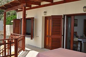 a house with a wooden door and a balcony at Villa Agalianos in Kerames