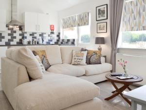a living room with a couch and a table at The Duck House in Ruckinge