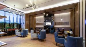 a restaurant with blue chairs and tables in a room at Echarm Hotel Nanning Chaoyang Square River View in Nanning