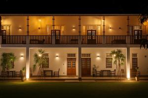 a building lit up at night with a patio at Ovenro Hotel Yala, Kataragama in Kataragama