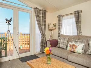 a living room with a couch and a table at Burray in Mey