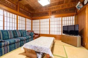 un salon avec un canapé et une télévision dans l'établissement Kumi No Yado Gettou - Vacation STAY 31704v, à Kadekaru