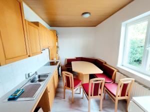 a small kitchen with a table and chairs and a sink at Guesthouse Graz Central for 9 People in Graz
