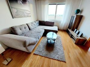 a living room with a couch and a table at Guesthouse Graz Central for 9 People in Graz