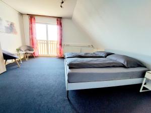 a bedroom with a bed and a large window at Guesthouse Graz Central for 9 People in Graz