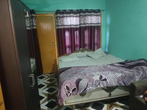 a bedroom with a bed and a door with curtains at Rajput restaurant and hotel in Ahraurā Road