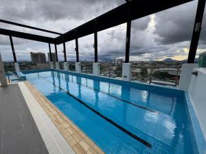 a large swimming pool on top of a building at Spacious 3BR Homestay - Trinity Residence Kuching City in Kuching
