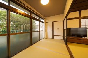 an empty room with a large window and a flat screen tv at Yufu no Yu Raku - Vacation STAY 18768v in Yufuin