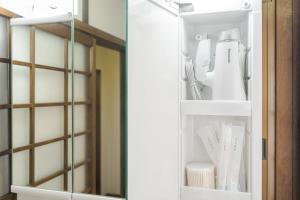 a cupboard filled with white utensils at Yufu no Yu Raku - Vacation STAY 18768v in Yufuin +23 photos