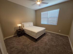 a bedroom with a white bed and a window at Comfortable Family Getaway in Buckeye in Buckeye