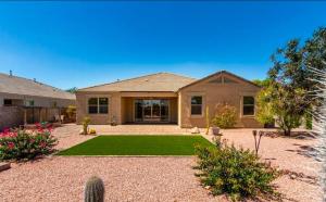 a large house with a yard with a lawn at Comfortable Family Getaway in Buckeye in Buckeye