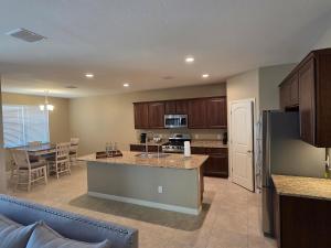 a kitchen and living room with a table and a refrigerator at Comfortable Family Getaway in Buckeye in Buckeye