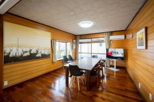 a dining room with a table and a painting of a herd of sheep at 晴宿-Hareyado 