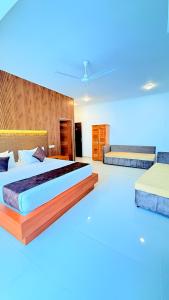 a large bedroom with two beds with blue lighting at Sevonra Beach Resort in Unawatuna +79 photos