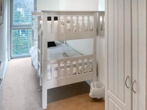 a white nursery with two bunk beds in a room at 12 Zinc in Newquay +6 photos