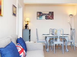 a living room with a couch and a table and chairs at Skyfall in Canterbury