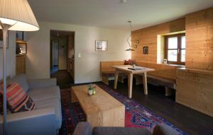 a living room with a couch and a table at Alpine Chalet Apartment With Zugspitze Views in Grainau