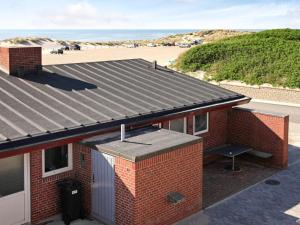 a red brick house with a view of the beach at 5 person holiday home in Henne-By Traum in Henne Strand