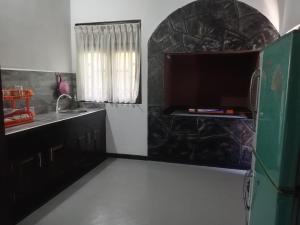 a kitchen with a sink and a counter top at The Onisula Guest House in Ahangama