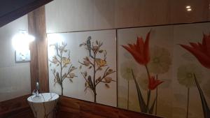 a bathroom with a flower mural on the wall at RKVilla in Tirupati