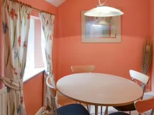 a dining room with a white table and chairs at Oak Cottage-16498 in Catcleugh