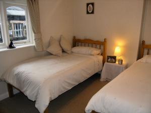 a bedroom with two beds and a window at Nu-Holme in Windermere