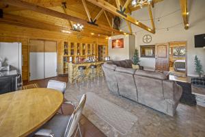 a large living room with a couch and a table at Ponderosa Inn in Escalante