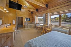 a bedroom with a bed and a bathroom with a tub at Ponderosa Inn in Escalante +17 photos