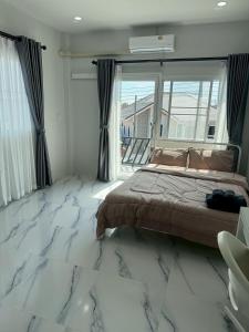 a bedroom with a bed and a marble floor at Together Stay Home in Mae Sai