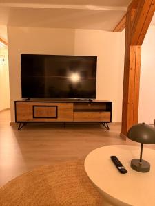 a living room with a large flat screen tv at Wohlfühloase Goslar no 3 in Goslar