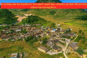 an aerial view of a village on a hill at Long Cổ Trấn Homestay in Dồng Văn