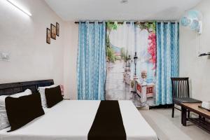 a bedroom with a bed and a desk and a window at Hotel O Basera in Dalhousie +23 photos