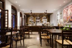 a restaurant with tables and chairs and a bar at Luna Mews - Ward place in Meda-Ela