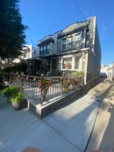 a house with a fence and flowers in front of it at Amazing private single family house in Glendale