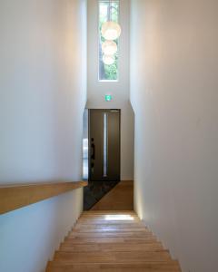 a hallway with a door and a window at Base 47 Hakuba by Jade Group in Hakuba