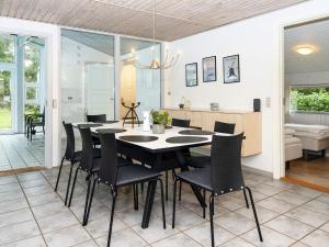 a dining room with a table and chairs at 8 person holiday home in Ørsted-By Traum in Kare +15 photos