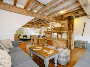 a living room with a couch and a table at The Water Mill in Bradbourne