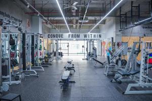 Un gimnasio con máquinas de cardio y un cartel que dice «Coraje desde dentro». en Anji Qijing B&B, en Huangshu